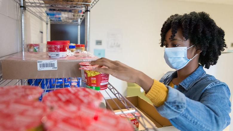 Angel Asomugha stocks Penn State Brandywine's food pantry.